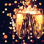 champagne glass against christmas sparkler background